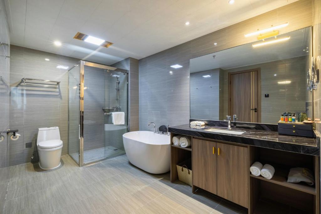 a bathroom with a tub and a sink and a shower at Citadines Zhengda Mall Hefei in Hefei