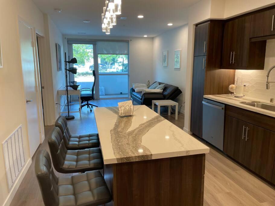 a kitchen and living room with a counter and a living room at Luxurious Apartment Bardeen New Port Beach 1 Bedroom in Irvine