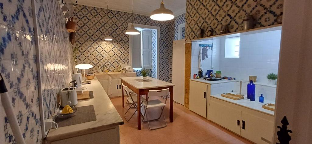 a kitchen with a sink and a counter in a room at A Casa do Tenente in Faro
