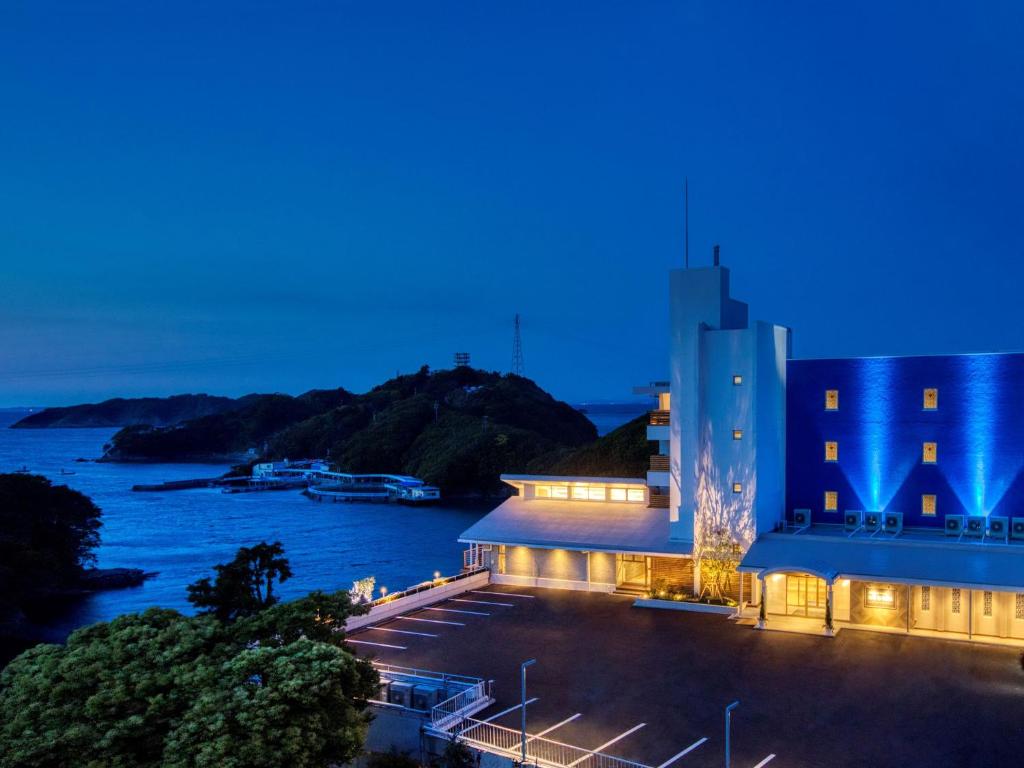 a view of a building at night with the water at Yukai Resort Premium Toba Saichoraku in Toba