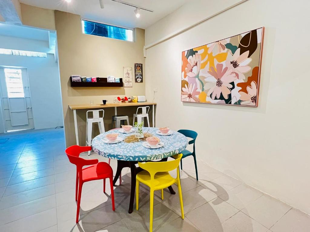 a dining room with a table and colorful chairs at myROOM @ Mandalay Georgetown, Off Jln Burma, Gurney Drive in George Town