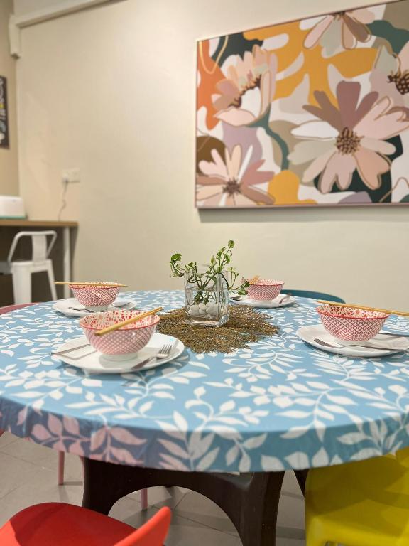 a blue and white table with bowls and plates on it at myROOM @ Mandalay Georgetown, Off Jln Burma, Gurney Drive in George Town