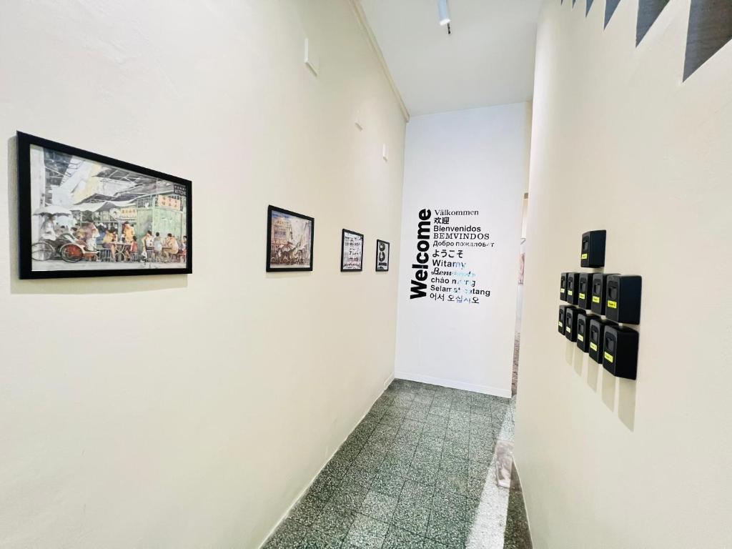 a hallway with pictures on the walls of a museum at myROOM @ Mandalay Georgetown, Off Jln Burma, Gurney Drive in George Town