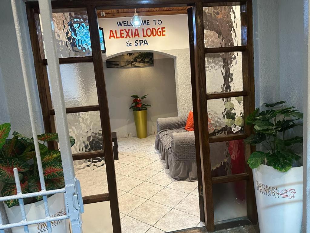 a door to azaia lodge and spa with a bed at ALEXIA LODGE & SPA in Cape Town