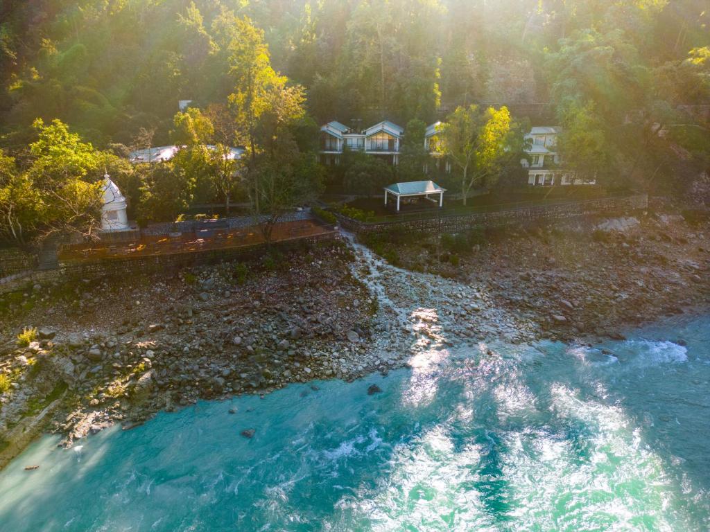 an aerial view of a river with a house at Anand Kashi by the Ganges Rishikesh - IHCL Seleqtions in Rishīkesh