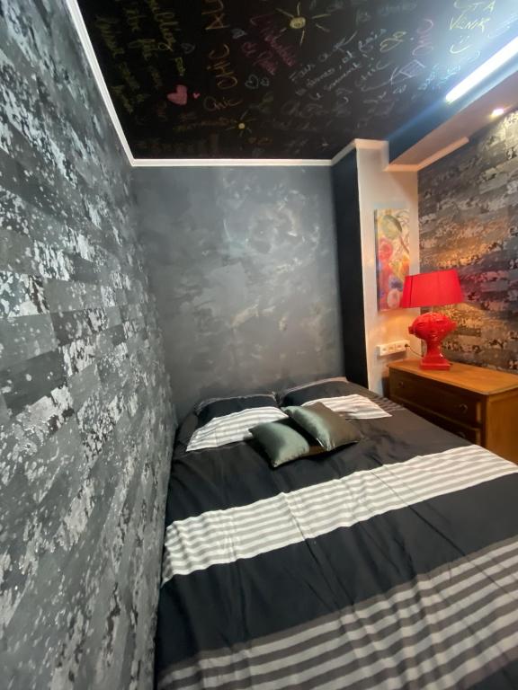 a bedroom with a bed and a wall with writing on it at LA MARIEFACTURE - Comme c&#39;est chic in Saint-Avold