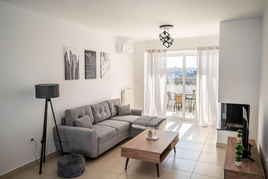 a living room with a couch and a table at Elegant apartment with breathtaking cityscape view (Drap_F5) in Piraeus