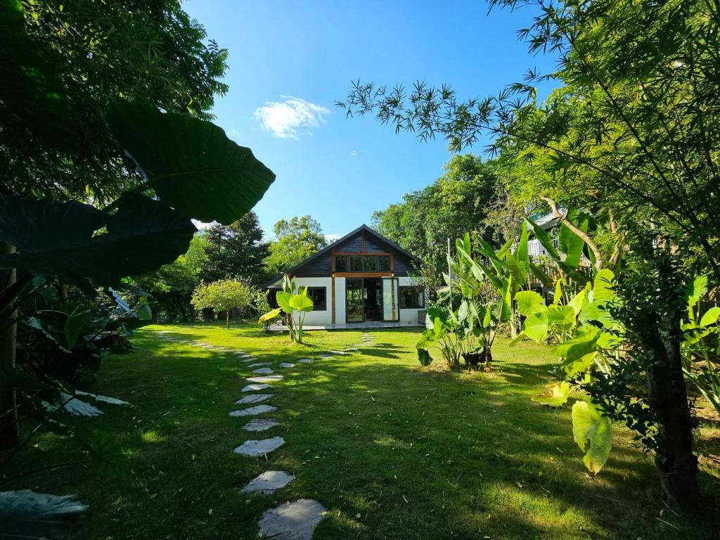 a garden with a house in the background at Lake House in Ha Giang