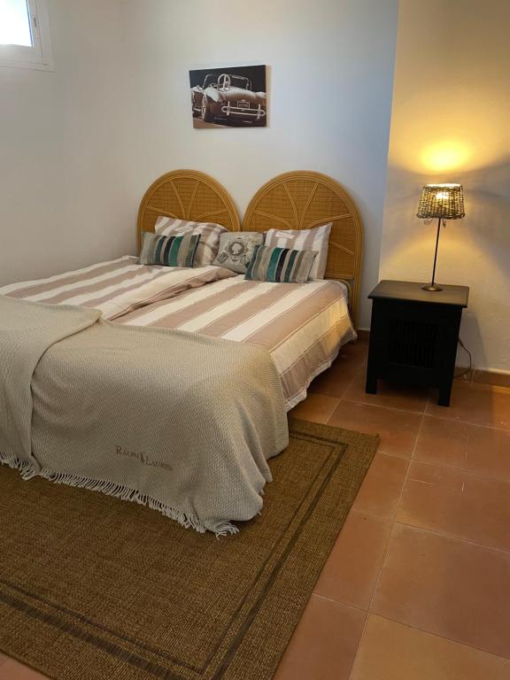 a bedroom with a large bed and a table at Apartment la Vida en Rosa in Marbella
