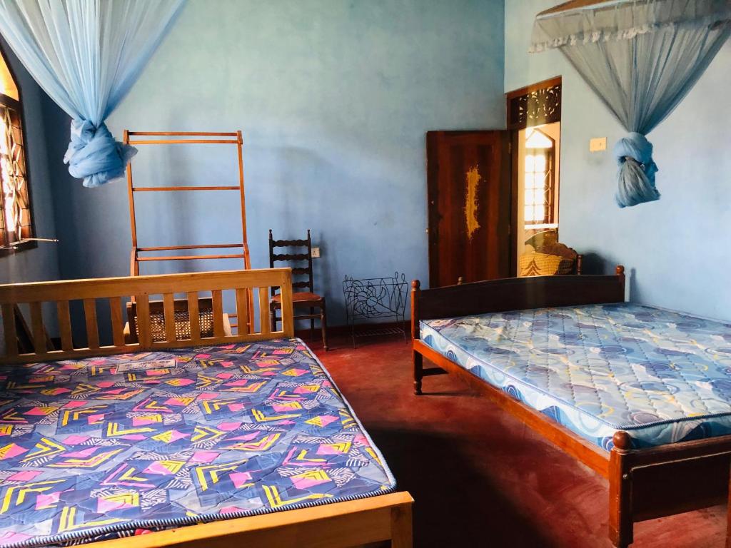 a bedroom with two beds in a room at MarvelMansion hostel in Galle