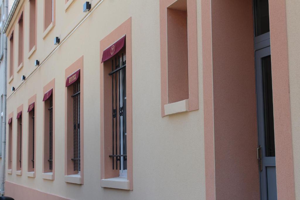 a row of windows on the side of a building at Hotel Jenner in Paris