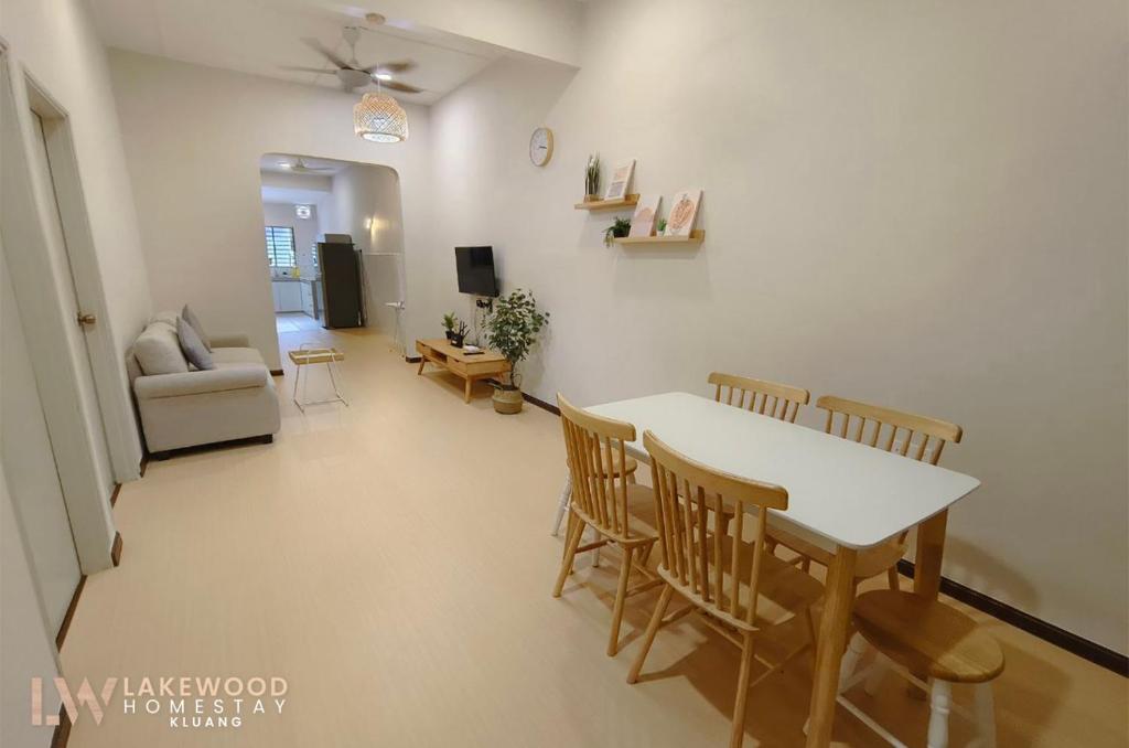 a dining room and living room with a table and chairs at Lakewood Muji Style Neflix Water Dispenser Near Aeon in Kluang
