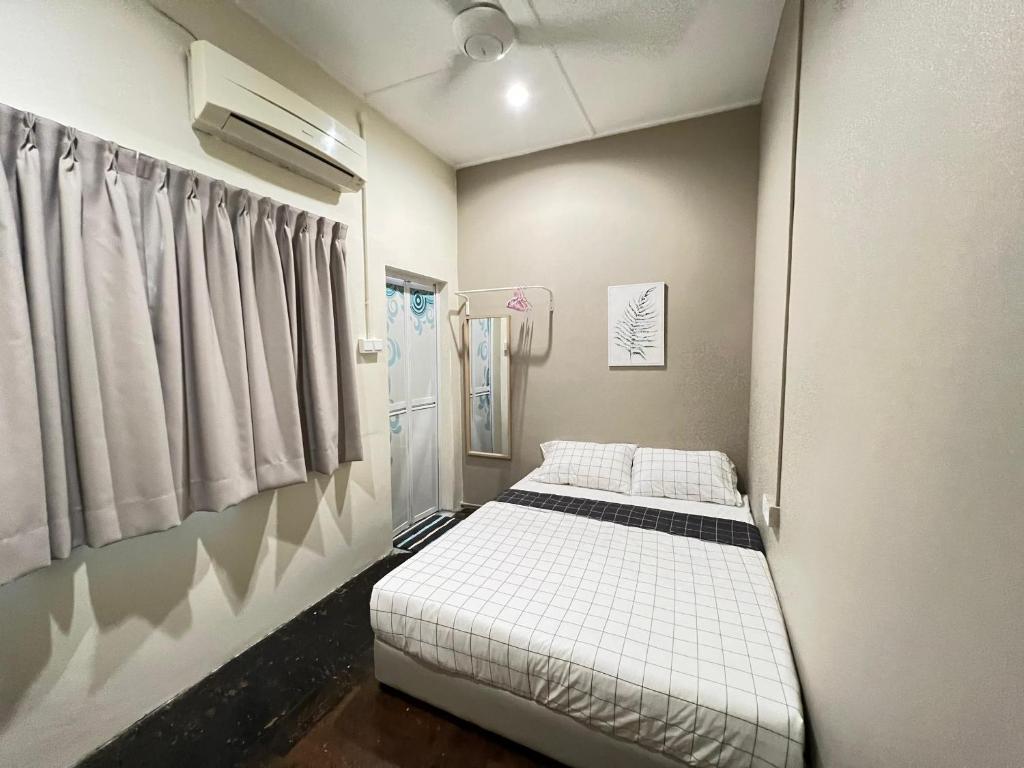 a small room with a bed and a window at myROOM @ Mandalay Georgetown, Off Jln Burma, Gurney Drive in George Town