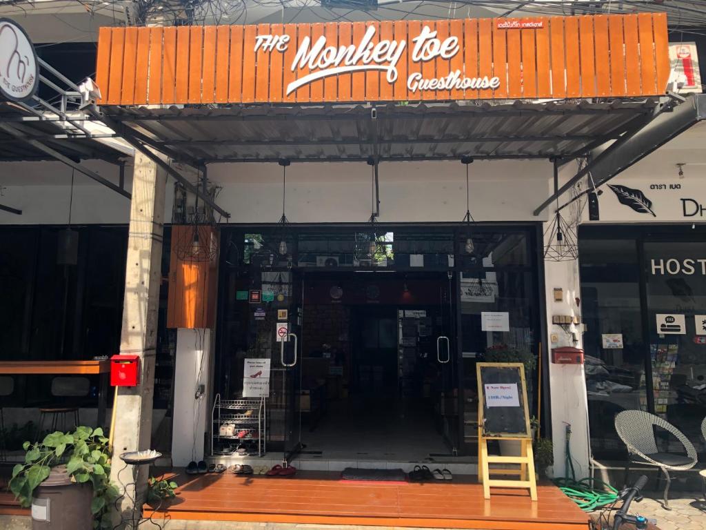 a building with the entrance to a motorcycle shop at Monkey Toe Guesthouse in Chiang Mai