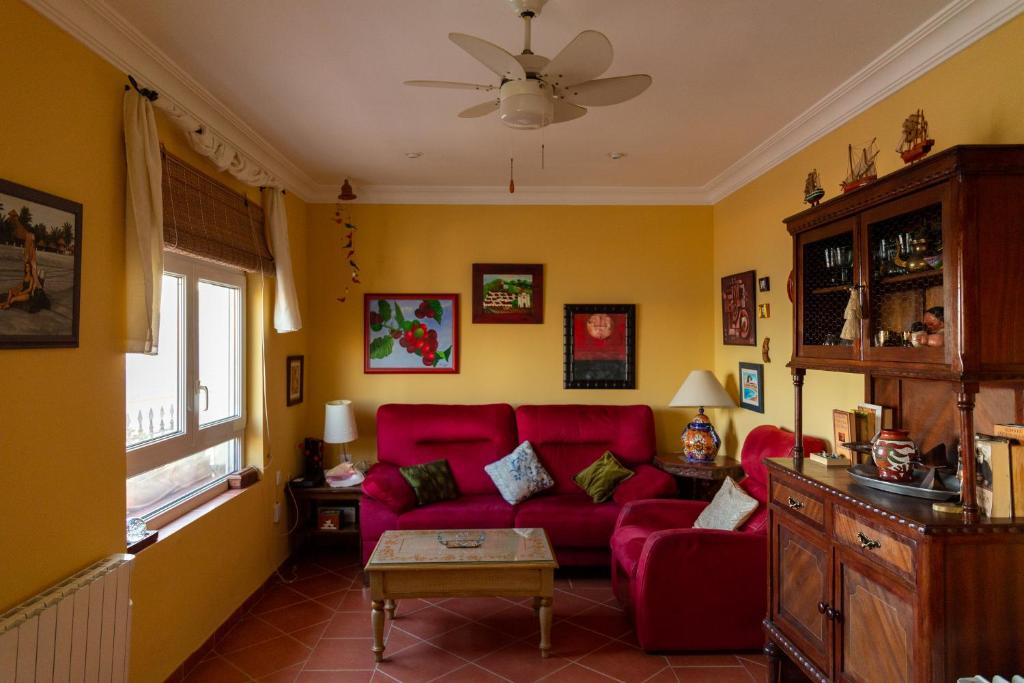 - un salon avec un canapé rouge et une fenêtre dans l'établissement La casa del mar by Gades Gestión, à Cadix