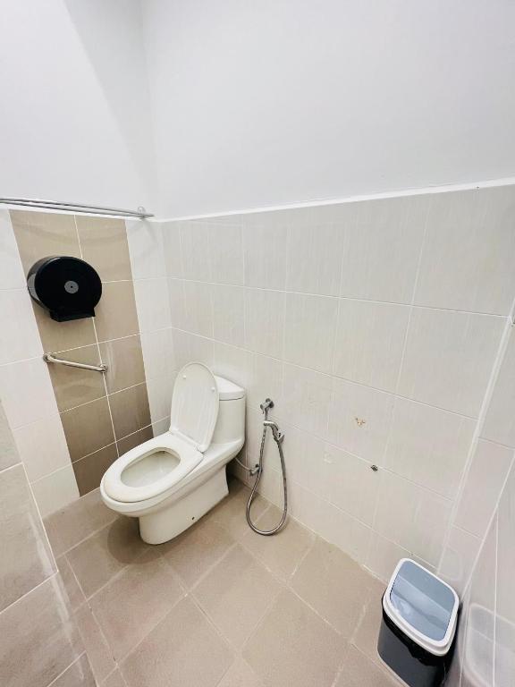 a bathroom with a toilet and a trash can at myROOM @ Mandalay Georgetown, Off Jln Burma, Gurney Drive in George Town