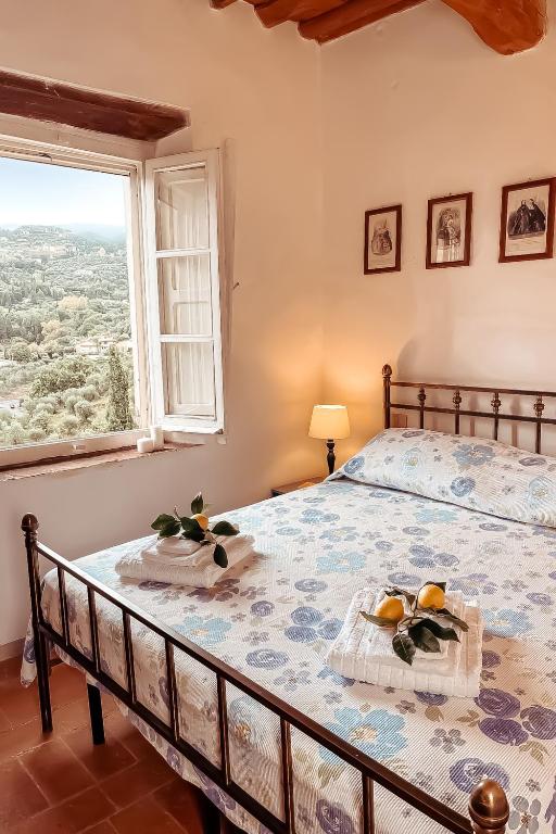 a bedroom with a large bed with a window at Sogno - Villa Cenami - grande PISCINA con vista in Massarosa