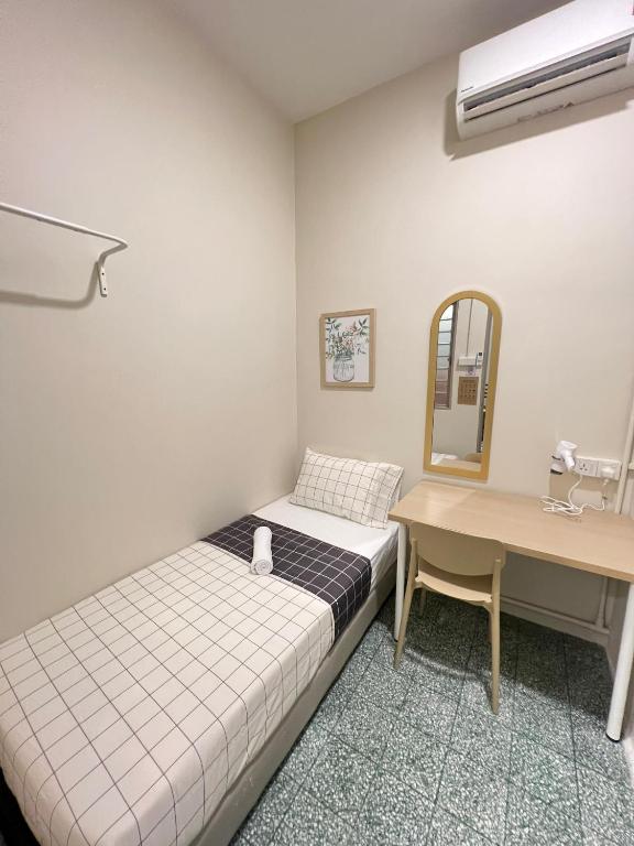 a bedroom with a bed and a desk and a mirror at myROOM @ Mandalay Georgetown, Off Jln Burma, Gurney Drive in George Town