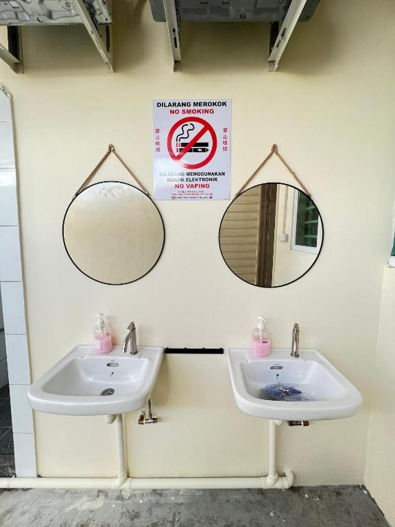 a bathroom with two sinks and two mirrors at myROOM @ Mandalay Georgetown, Off Jln Burma, Gurney Drive in George Town