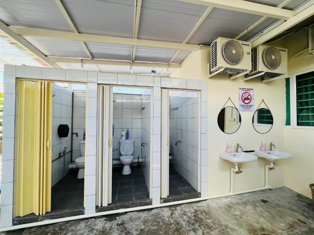 a bathroom with two sinks and a toilet at myROOM @ Mandalay Georgetown, Off Jln Burma, Gurney Drive in George Town