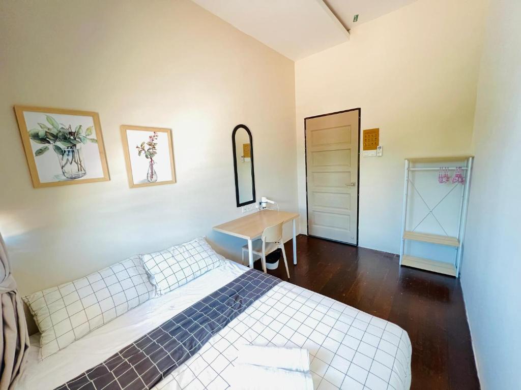 a bedroom with a bed and a table and a desk at myROOM @ Mandalay Georgetown, Off Jln Burma, Gurney Drive in George Town