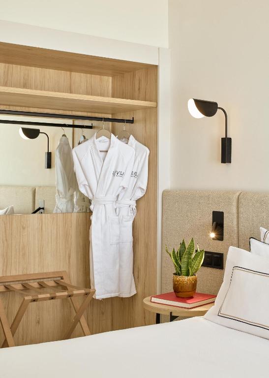 a room with a white robe hanging on a closet at Meliá Lloret de Mar in Lloret de Mar