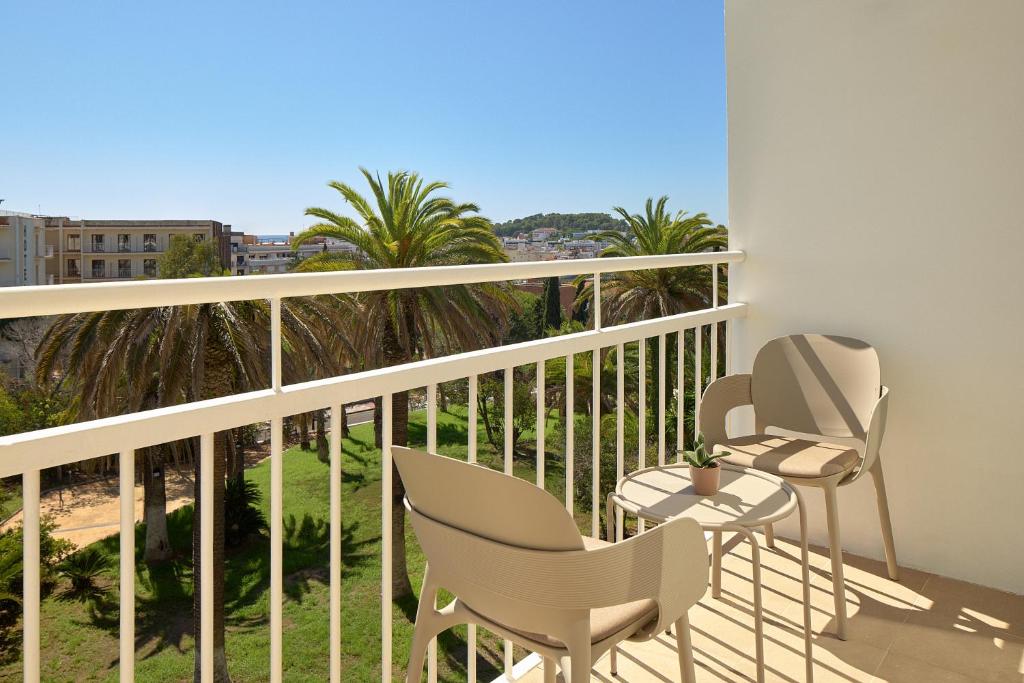 a balcony with two chairs and a table at Meliá Lloret de Mar in Lloret de Mar
