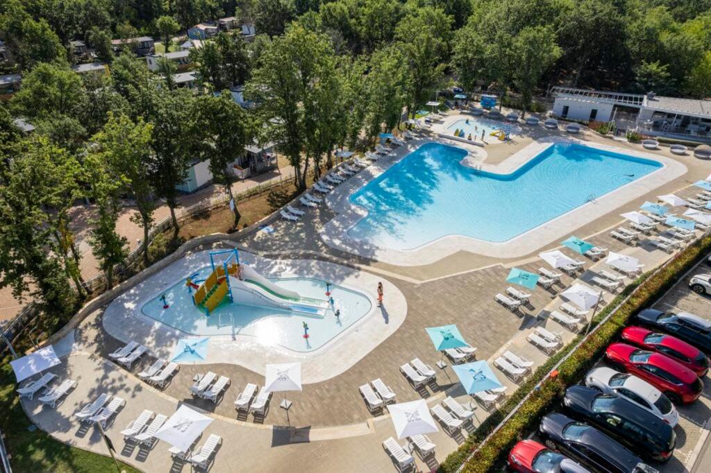 an overhead view of a large swimming pool with chairs at Easyatent Bungalow tent Bijela Uvala in Poreč