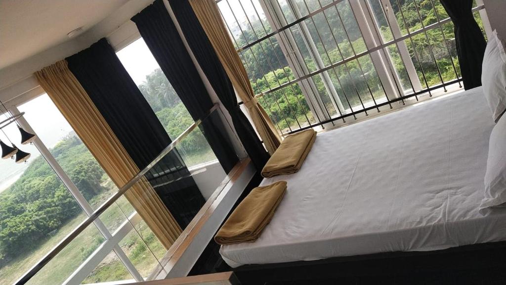 Postel nebo postele na pokoji v ubytování Mer Vue Villa, Kovalam, ECR, Chennai