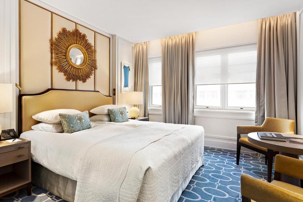 a hotel room with a large bed and a desk at Hotel Continental in Oslo