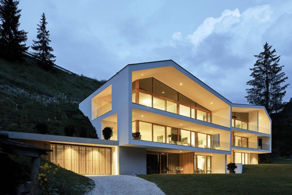 a modern house on top of a hill at Greva Apartments 1 in Santa Cristina in Val Gardena