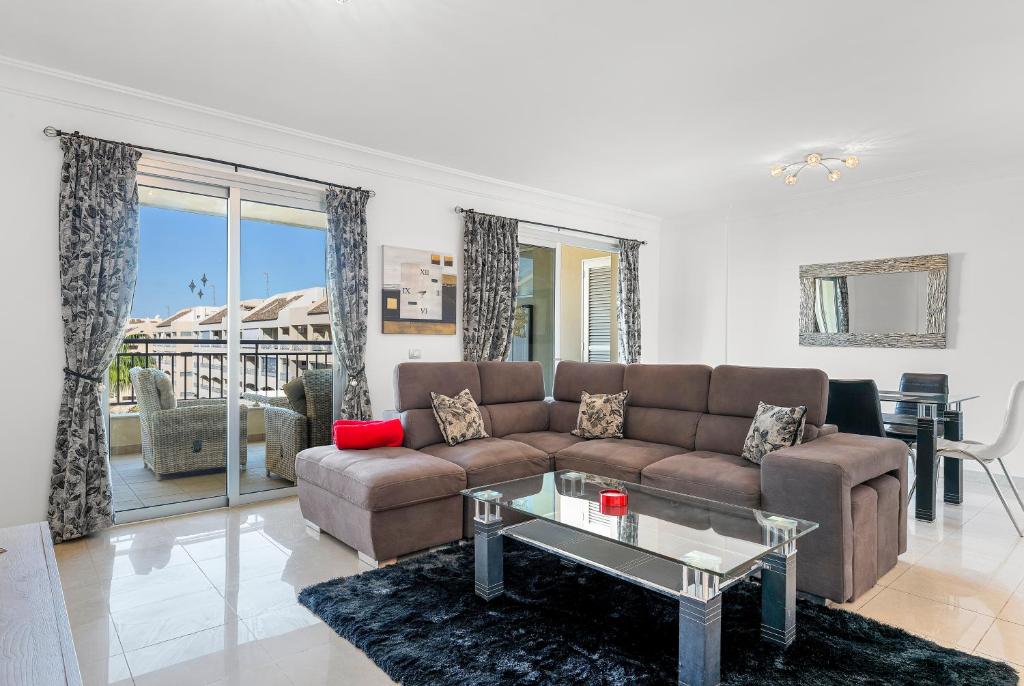 a living room with a couch and a table at Palm Mar Penthouse Duplex in Palm-mar