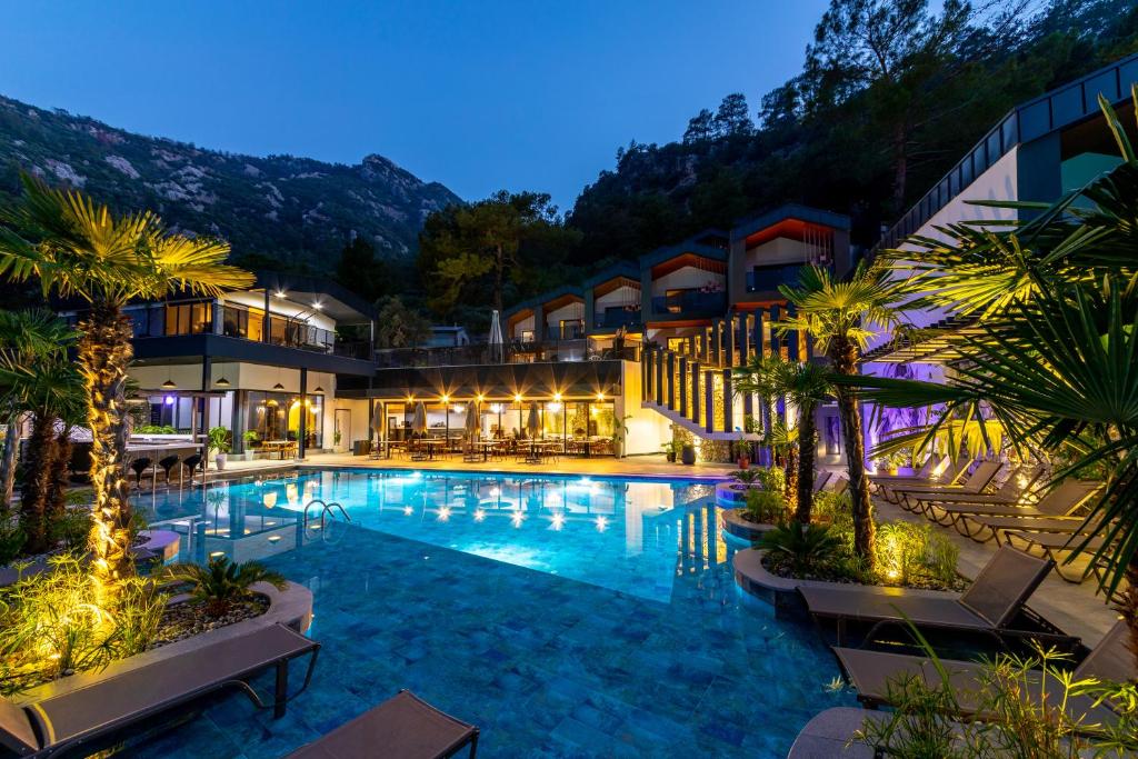 a hotel with a swimming pool at night at Ramitos Boutique Hotel in Marmaris