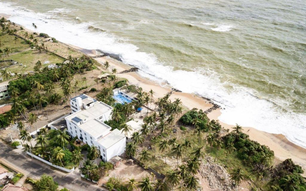an aerial view of a house and a beach at Sea Shine Beach Hotel 