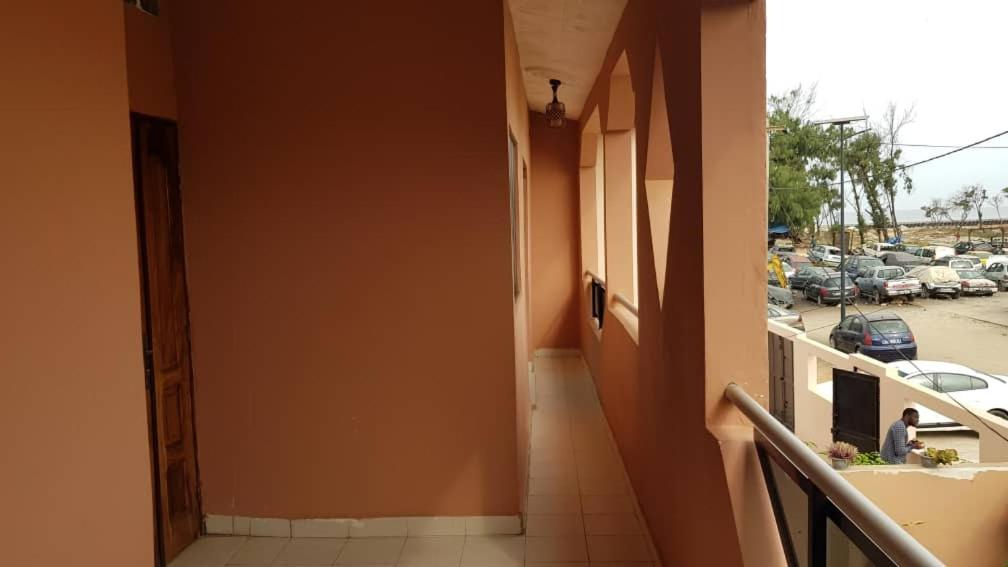 a hallway of a building with a view of a parking lot at Lowéne in Guediawaye