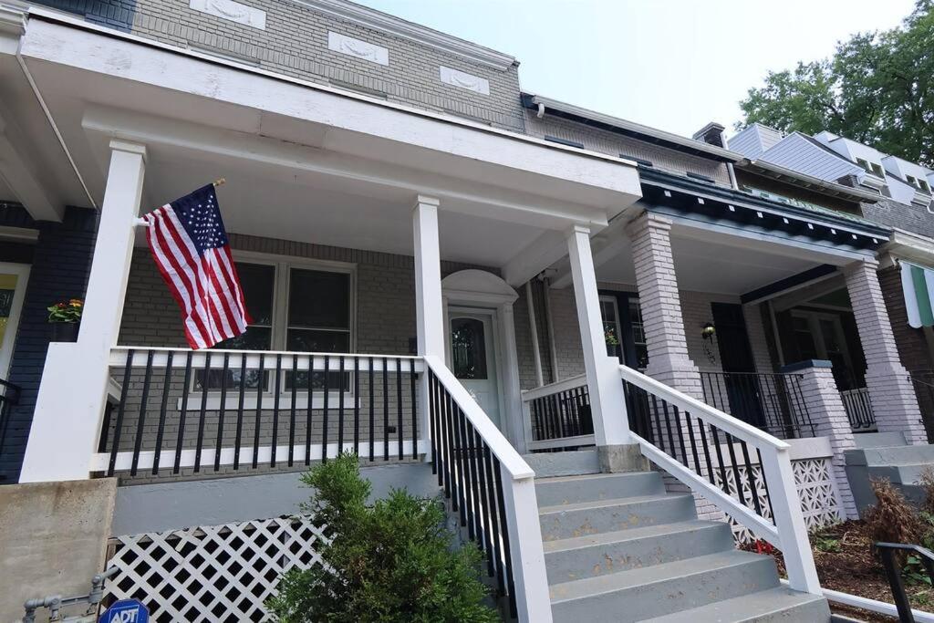 an american flag on the front porch of a house at Two DC Rowhouses Large Groups Sleeps 21 in Washington