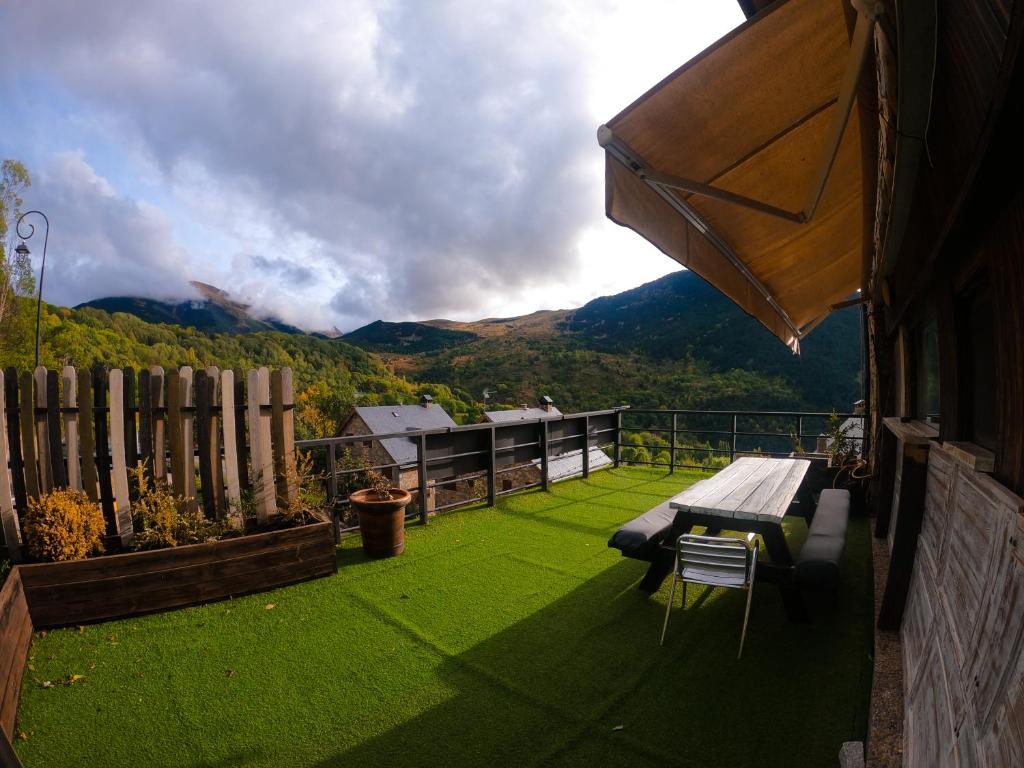 a patio with a bench and a view of a mountain at Apartments Taull in Taüll