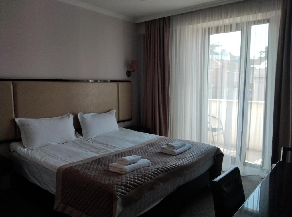 Postel nebo postele na pokoji v ubytování Hotel Genio