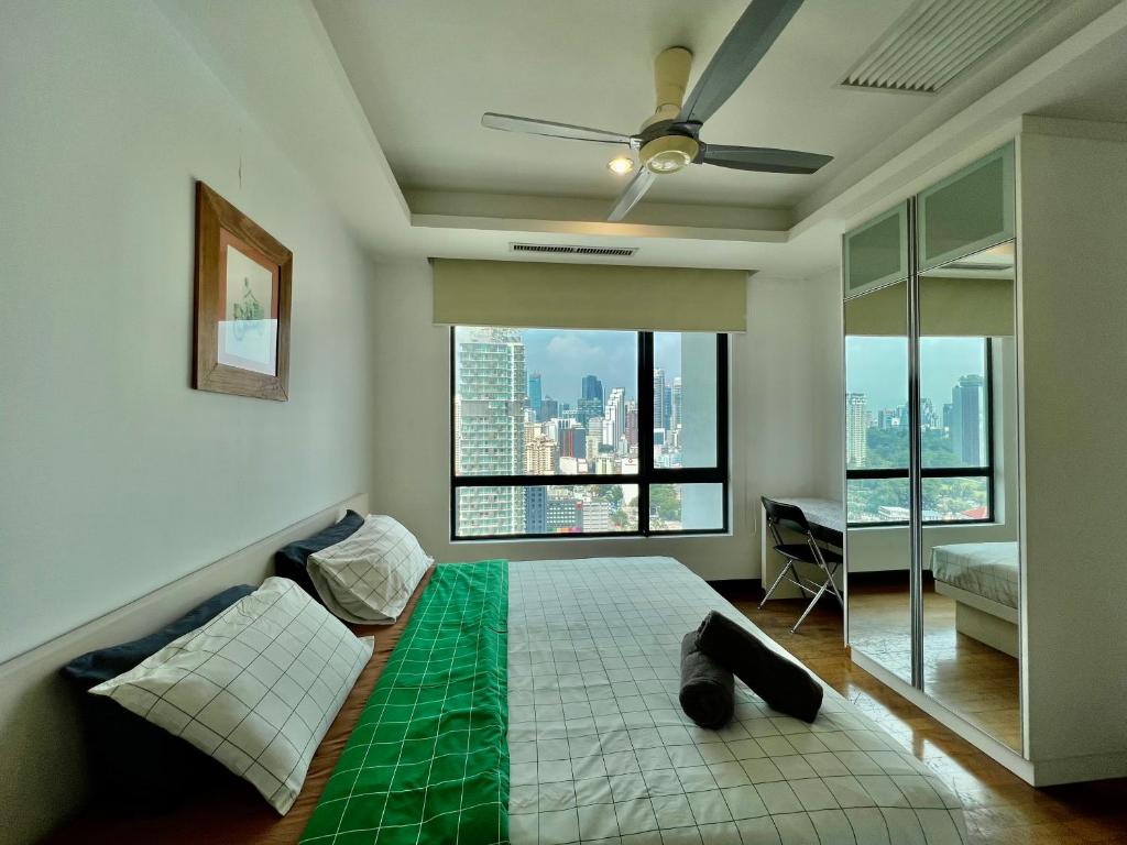 a bedroom with a bed and a large window at Casa Residency in Kuala Lumpur