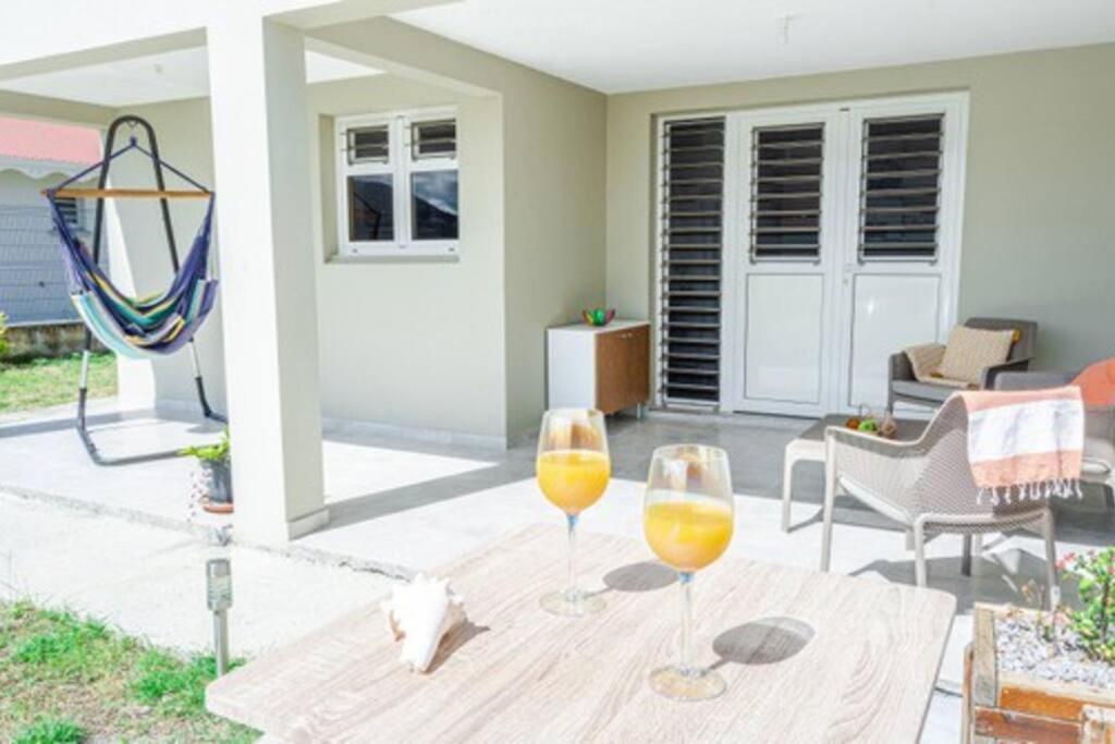 2 verres à vin assis sur une table en bois sur une terrasse dans l'établissement La casa tropicale, au François