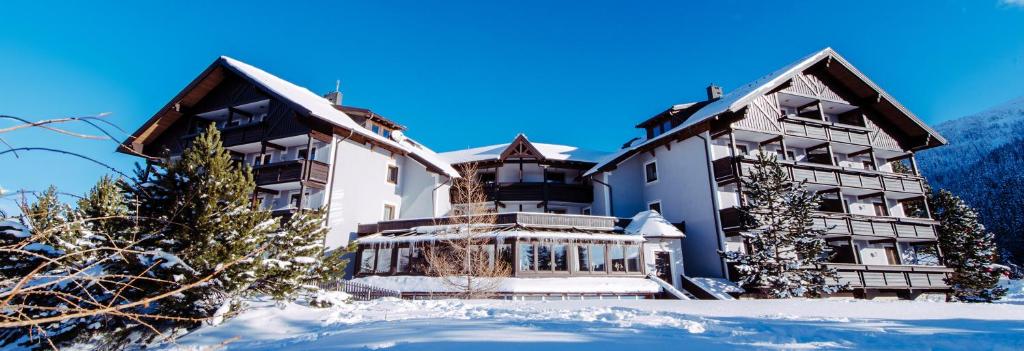 a large house in the snow in front at GMS Holidays in Katschberghöhe