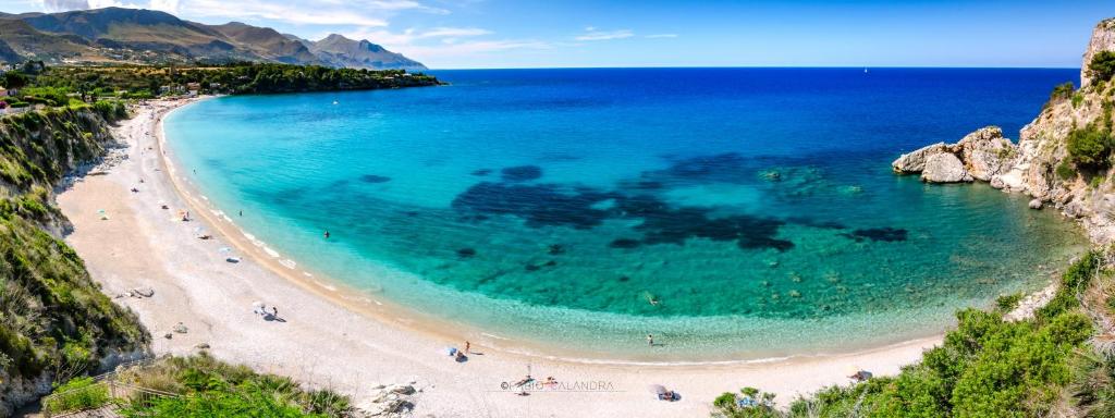 an aerial view of a beach with people in the water at Stunning Seafront Villa in Scopello Pool & Jacuzzi in Scopello