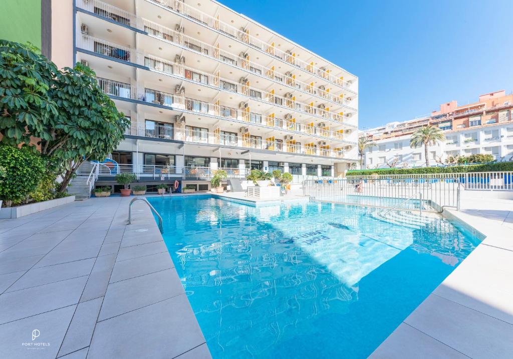 a swimming pool in front of a building at Port Vista Oro in Benidorm