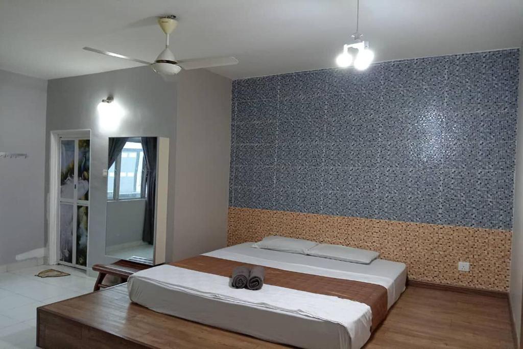 a bedroom with a large bed and a wall at Aeon Tebrau Apartment Johor Bahru - By Room - in Johor Bahru