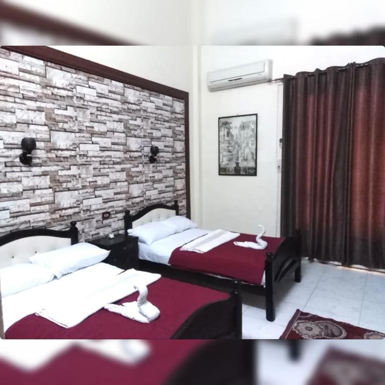 Postel nebo postele na pokoji v ubytování New Palace Hotel