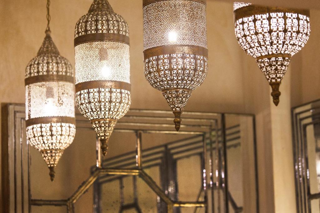 a group of chandeliers hanging from the ceiling at Algilà Ortigia Charme Hotel in Siracusa