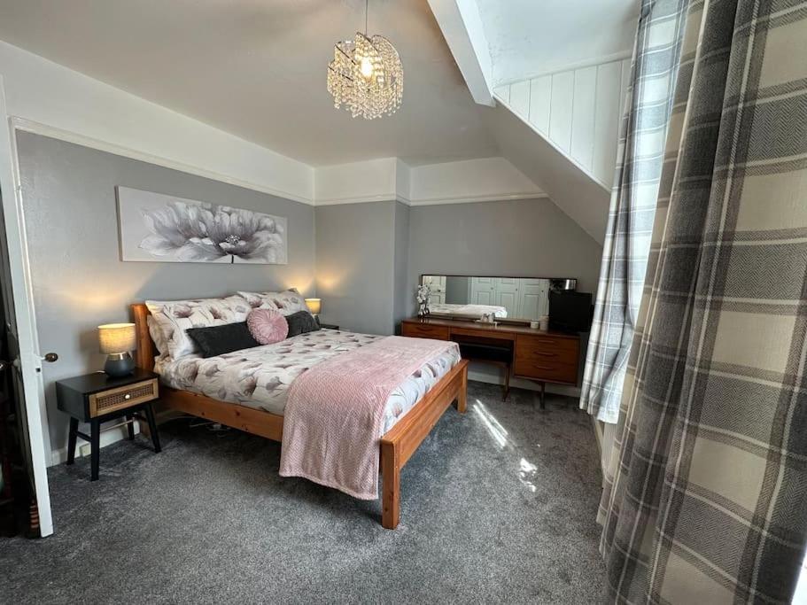 a bedroom with a bed and a desk in it at Cosy Stay in the Heart of Dover in Kent