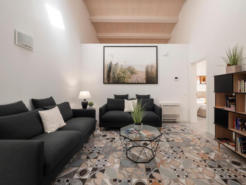 a living room with a couch and a table at Zuara9Room Rimini in Rimini