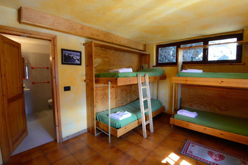 Posteľ alebo postele v izbe v ubytovaní Rifugio Vieux Crest