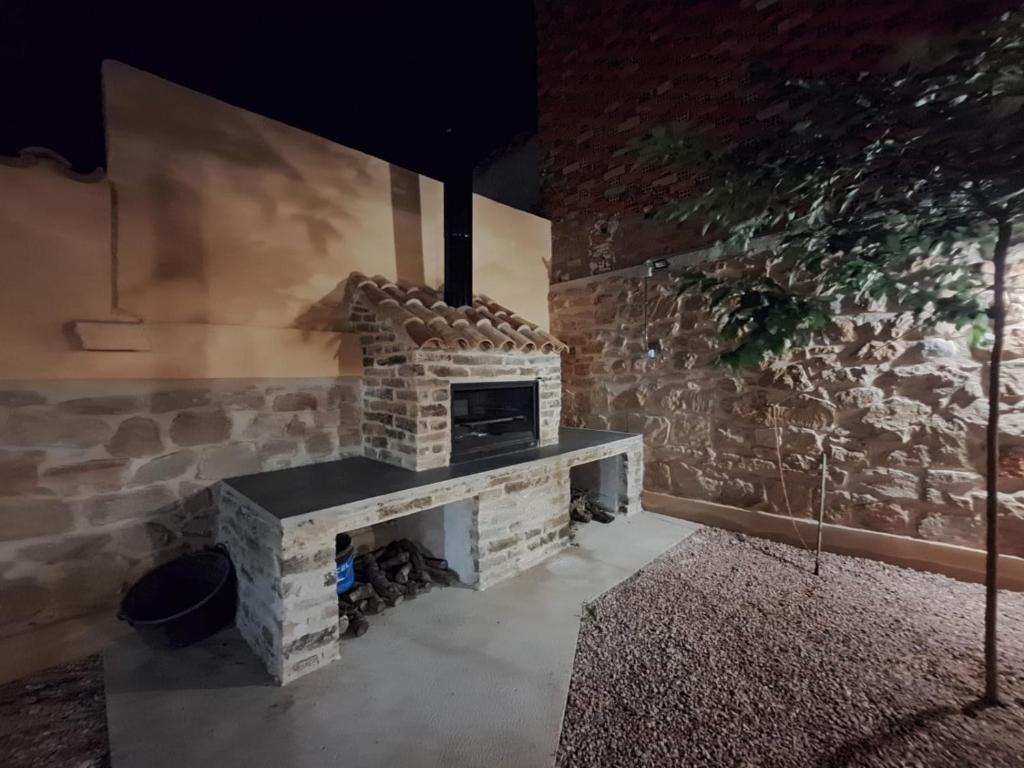 a stone fireplace in a room with a stone wall at Apartamento Clau in Puigmoreno